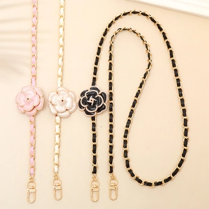 Macro view of camellia flower leather-woven metal chain straps for handbags and phones