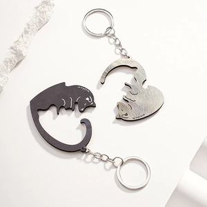 Detailed view of heart-shaped puzzle cat keychain set in black and silver metal