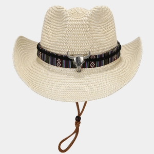 Close-up of beige straw cowboy hat featuring ethnic band and silver bull skull detail
