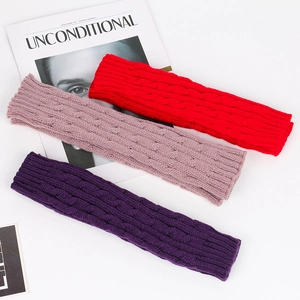 Detailed cable knit texture of red, pink, and purple long fingerless gloves