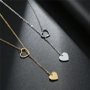 Minimalist titanium steel heart pendant necklace in gold and silver on black background