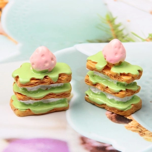Macro shot of miniature resin strawberry matcha cake models for DIY jewelry and decor