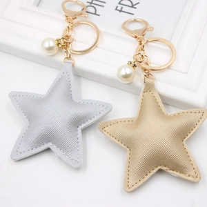 Star-shaped PU leather keychains in gold and silver colors with pearl and rhinestone charms
