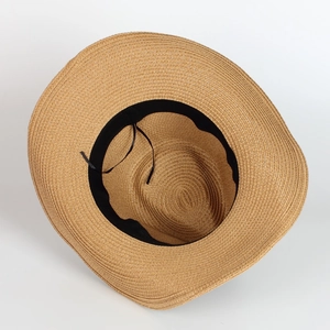 Macro shot of straw sun hat interior with adjustable black drawstring for custom sizing