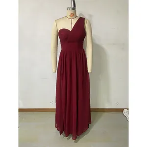 Detail of burgundy one-shoulder dress showing criss-cross pleated bodice and chiffon fabric