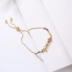 Adjustable gold-plated fishbone bracelet featuring colorful zircon stones on a white background