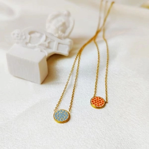 Gold stainless steel birthstone necklaces with light blue and orange crystal pendants
