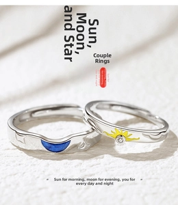 Macro shot of sun and moon couple rings featuring blue enamel star and yellow sun detail