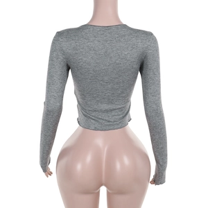 Back view of a grey long sleeve cropped knitted tee on a professional display mannequin