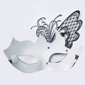 Close-up of a luxury white masquerade mask with black butterfly wing cutout detail