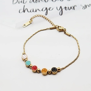 Golden titanium steel bracelet with five colorful smiley face charms on white background