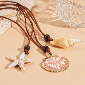 Bohemian beach necklace featuring seashell starfish pendants and brown suede cord