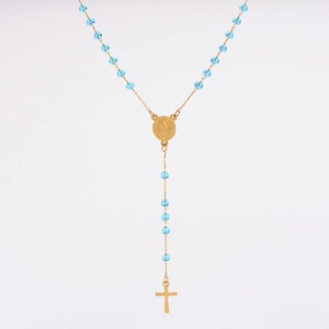 Detail of gold rosary necklace with light blue faceted beads and a religious medal
