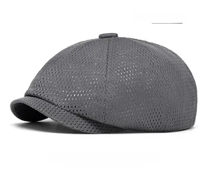 Detail of dark gray summer beret showing breathable mesh fabric and top decorative button