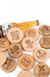Macro detail of round wooden magnetic beer bottle openers with laser engraved designs