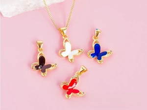 Detail of four colorful butterfly pendants in black white blue red with gold trim