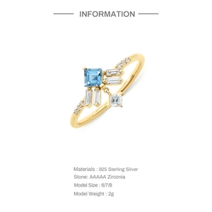 Macro detail of gold plated 925 sterling silver ring with blue zircon stone and diamonds