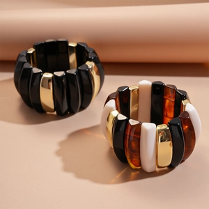 Modern acrylic beaded bracelets with black, amber, and gold geometric resin blocks