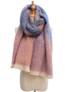 Detail of gradient blue and pink bouclé yarn scarf with fringe on a mannequin