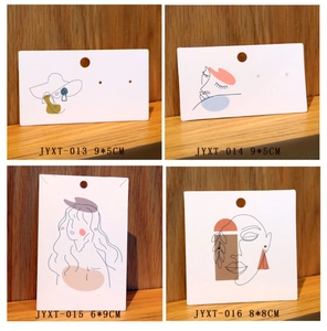 Minimalist line art jewelry display cards for earrings and necklaces on wood surface