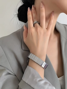 Polished silver cuban link watch-band bracelet and matching ring on model in suit
