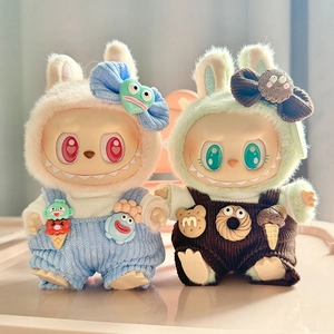 Close-up of cute corduroy overalls and bow accessories for plush doll pendants