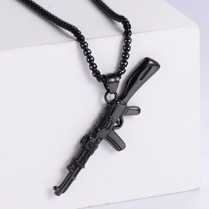 Tactical AK47 gun pendant necklace in gun black finish on white cube display