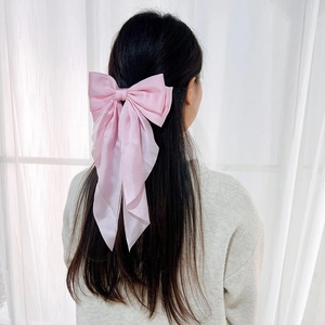 Pink satin bow hair clip with long ribbons for women, elegant hairstyle accessory