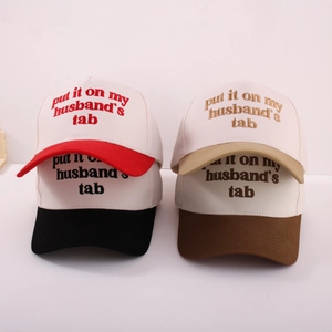 Close-up of embroidered typography on two-tone vintage cotton trucker caps for men and women