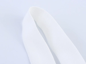 Detailed macro view of white woven fabric texture and thick elastic ribbon material