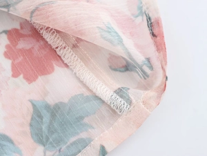 Detail view showing professional stitching and floral print on lightweight summer chiffon