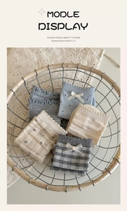 Detail of assorted blue and grey crew socks with ribbon bows and lace trim in a basket