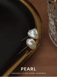 Detail view of Baroque freshwater pearl earrings with S925 sterling silver posts on a plate