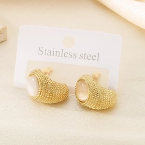 Detailed macro of gold stainless steel earrings with cat eye stone and beaded texture