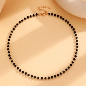 Macro view of gothic black beaded necklace with golden adjustable lobster clasp and chain