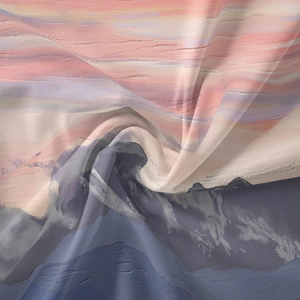 Detail of bohemian mandala tapestry showing gradient fabric texture and artistic pleated folds