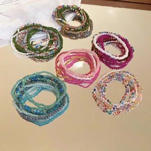 Bohemian style stackable bead bracelet set with seven colorful layers on a mirror tray