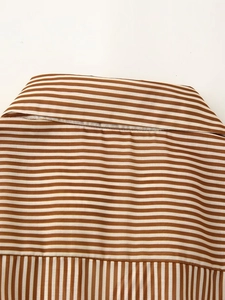 Detail of rear neckline and vertical pleats on brown striped shirt dress