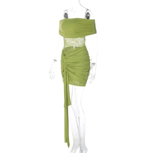 Detail of green off-shoulder dress featuring ruched fabric and sheer floral lace waist