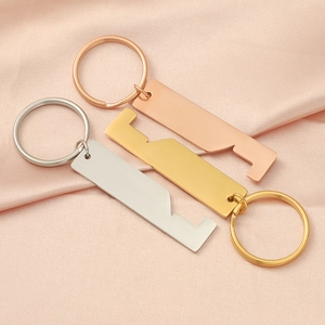 Detailed view of polished house-shaped metal keychains in silver, gold, and rose gold