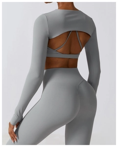 Close-up of crescent back cutout on grey athletic yoga top and high-waisted leggings