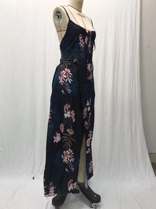Detail view of floral print maxi dress featuring thin straps and a side leg slit