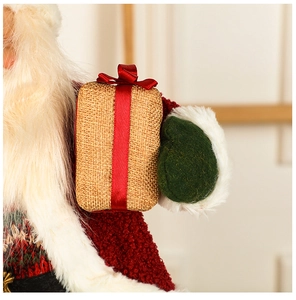 Detailed close-up of a Santa doll showing knit collar and linen gift box textures