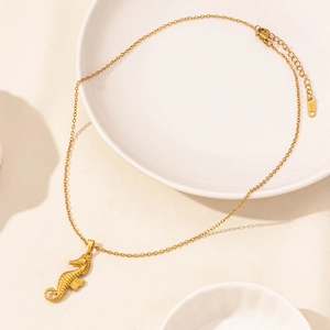 Detailed view of a golden seahorse pendant and S.Steel tag on a high-quality chain