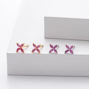 Detailed view of pink zircon flower stud earrings in gold and silver finishes