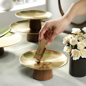 French style gold metal fruit tray with dark wood base for elegant home dessert serving