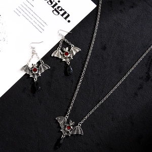 Gothic bat jewelry set with red gems and black teardrop pendants on a necklace and earrings