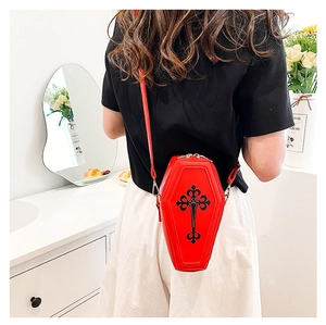 Detail view of red coffin-shaped gothic crossbody bag with black cross on PU leather