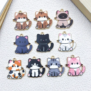 Detailed view of ten colorful enamel cat charms with gold-plated borders in various breeds