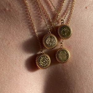Vintage gold coin necklace with 12 zodiac embossed charms and sunburst edge design